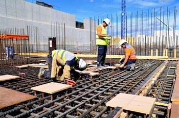 Embedded plates are inserted into the rebar lattice prior to pouring concrete. Each plate is positioned in accordance with the 3D Configuration Management Model and tuned with a theodolite in order to be level with the future concrete surface. (Click to view larger version...)